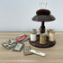 Vintage wooden sewing stand for six spools of thread and topped with a pin cushion.