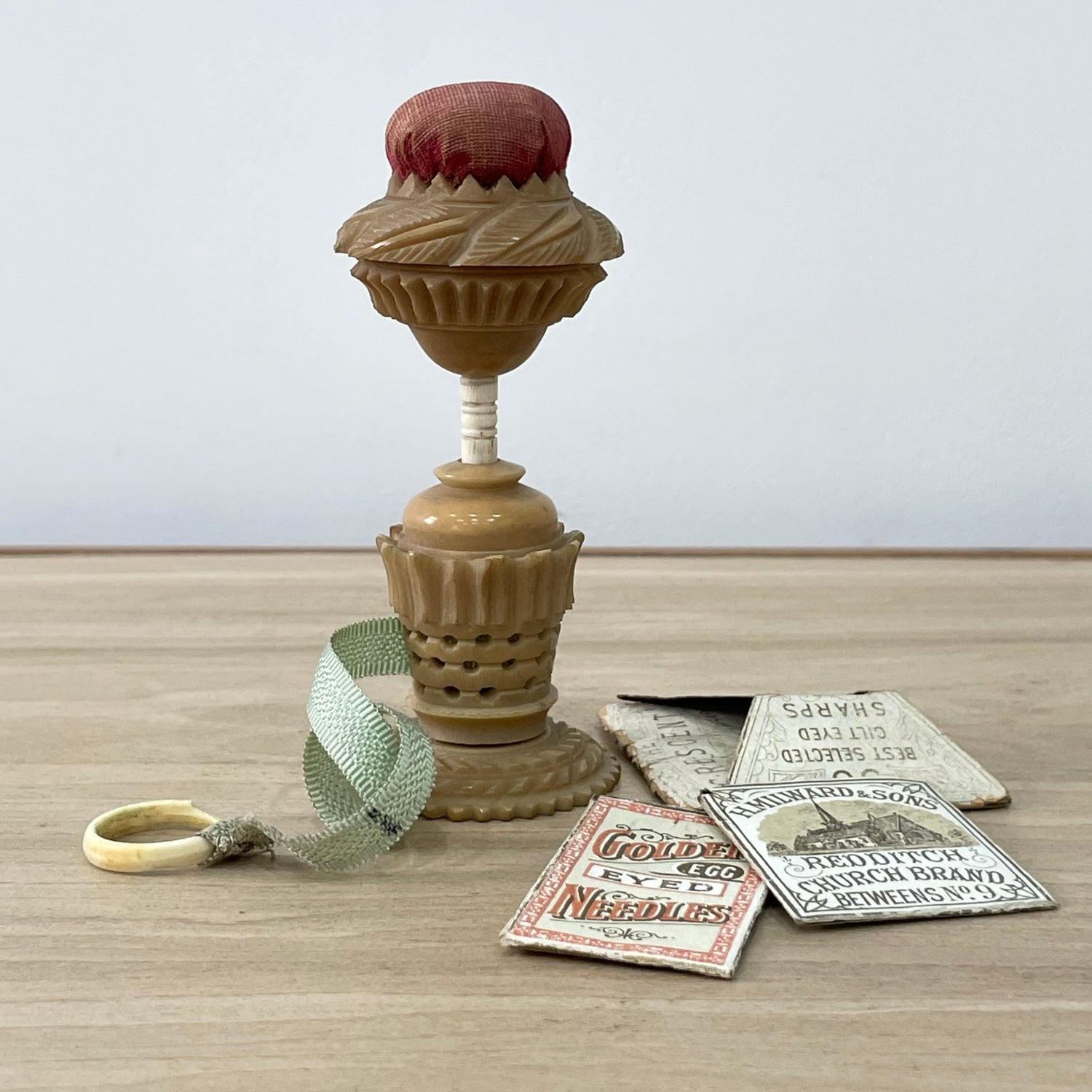 Antique Tagua Nut Pin Cushion with light green tape measure